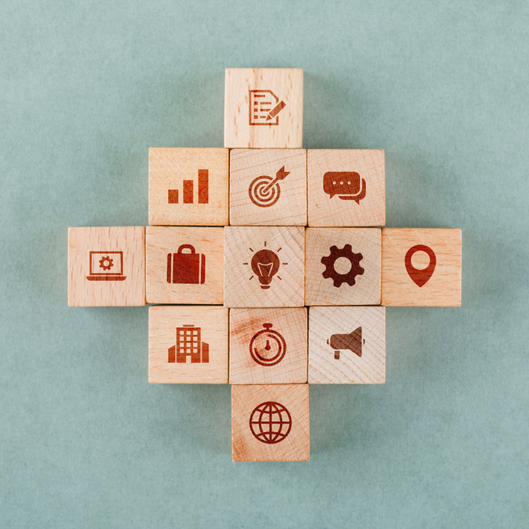 Business strategy concept with wooden blocks with icons on sage