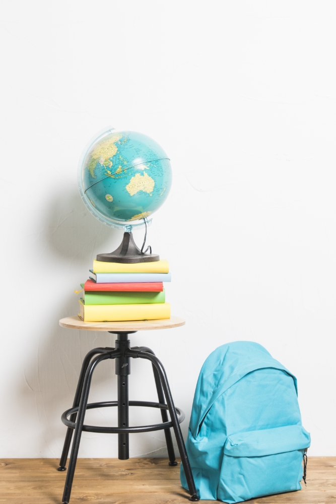 globe-books-placed-stool-chair-schoolbag